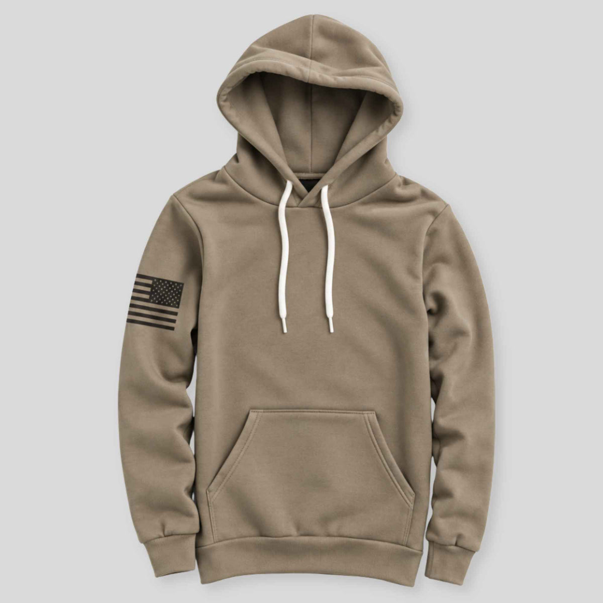 A khaki brown pullover hoodie with white drawstrings and a black American flag graphic on the right sleeve, displayed against a solid light gray background.