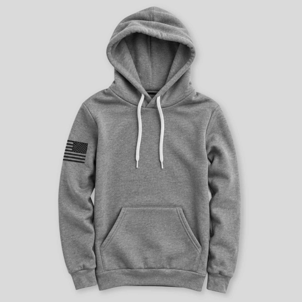 A heather gray pullover hoodie with white drawstrings and a black distressed American flag patch on the left sleeve, shown against a solid light gray background.