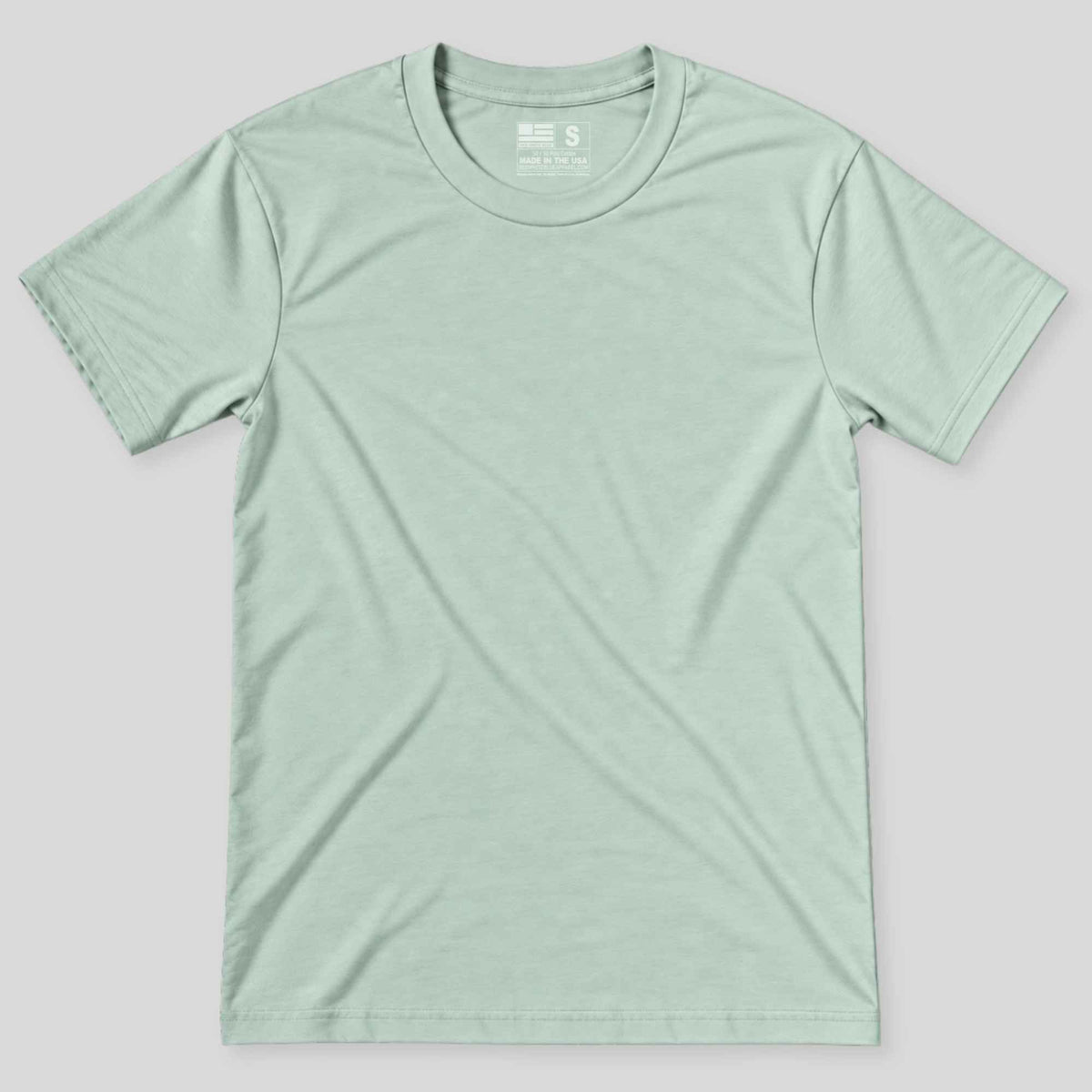 A light sage green crewneck t-shirt laid flat against a neutral gray background.